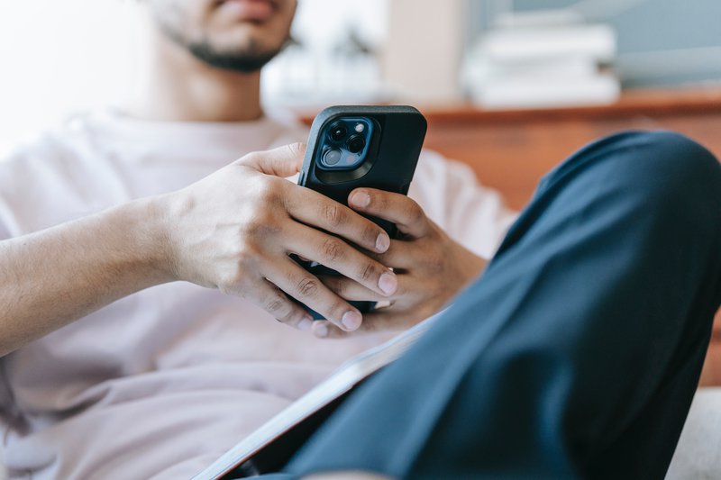 man checking sms in mobile phone